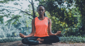 A person meditating in a peaceful outdoor setting.